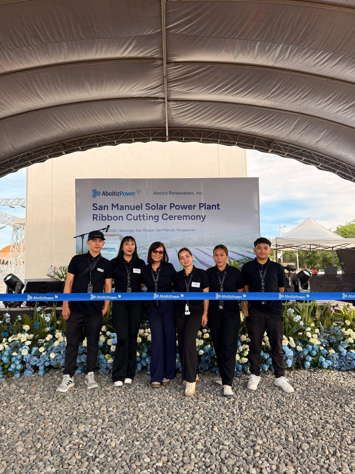 The team in black uniform at the San Manuel Solar Power Plant ribbon-cutting ceremony, under a marquee
